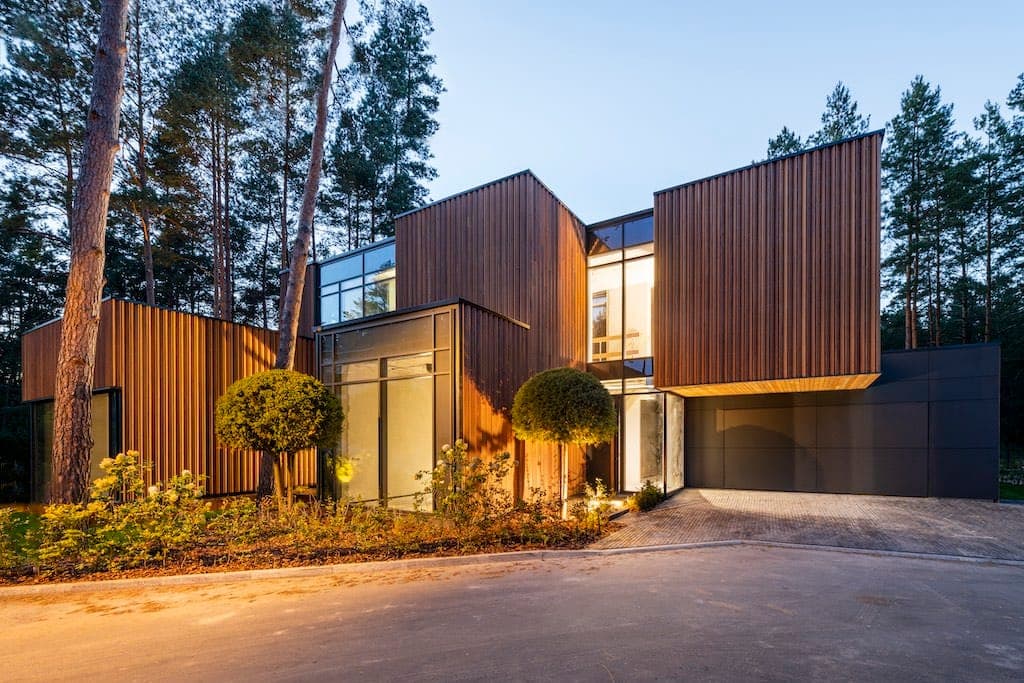 ZEN House — at dusk, timber cladding warm against the dark garage volume
