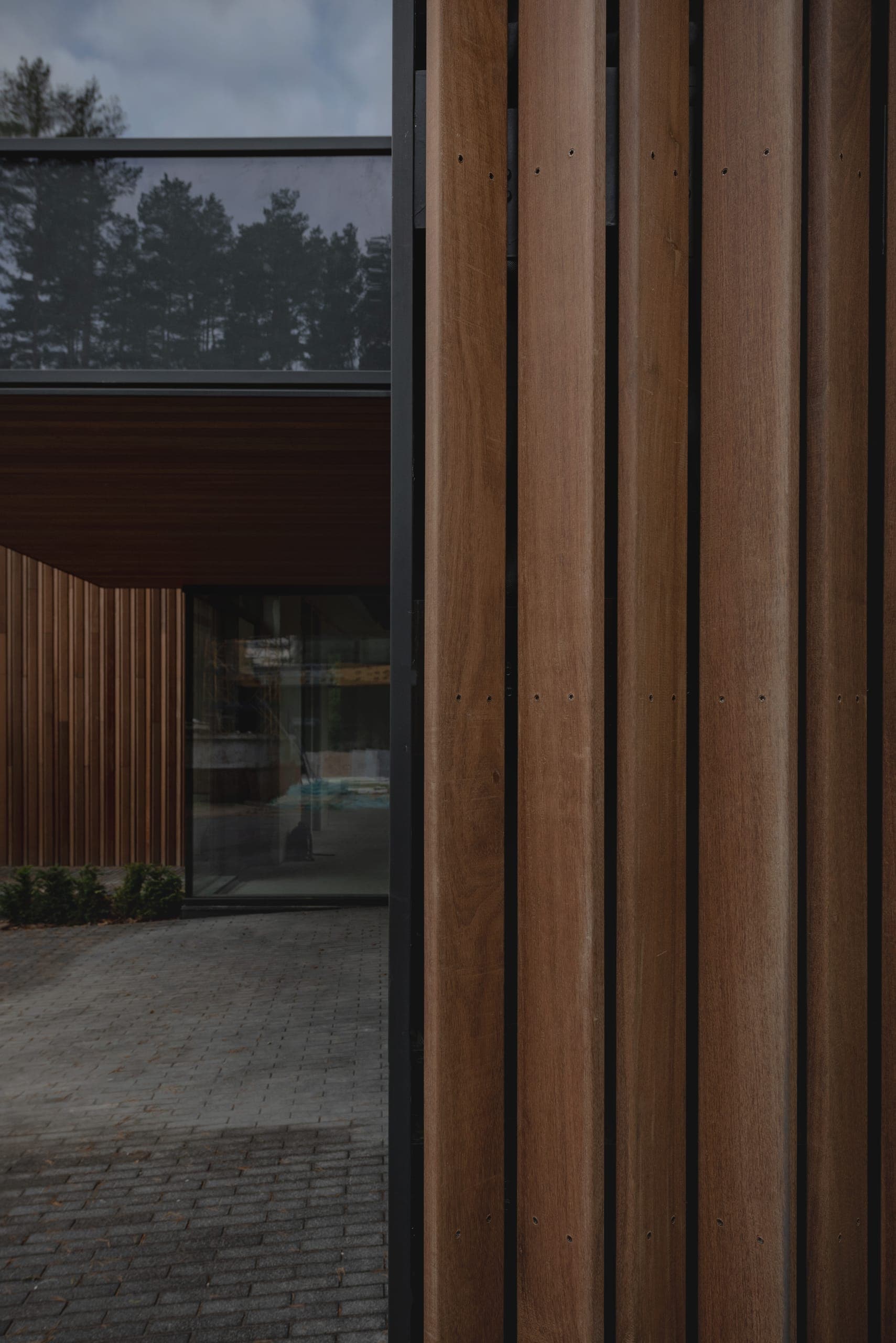 ZEN House — close view of vertical timber battens beside a glazed opening