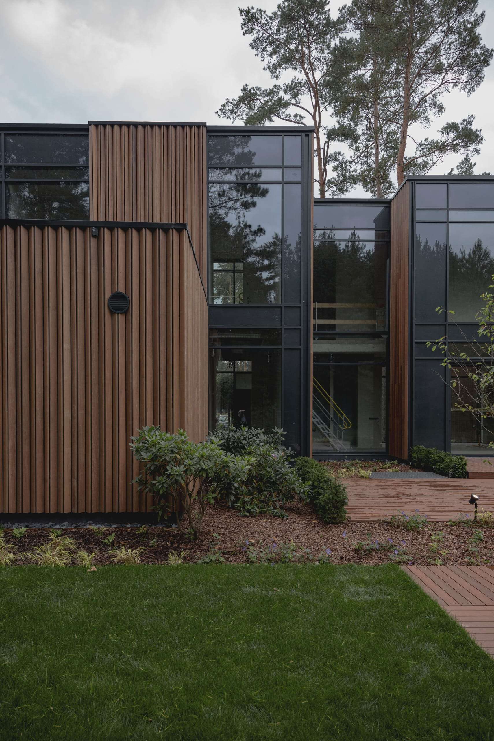 ZEN House — inner courtyard, glazing wrapping a stair between timber volumes