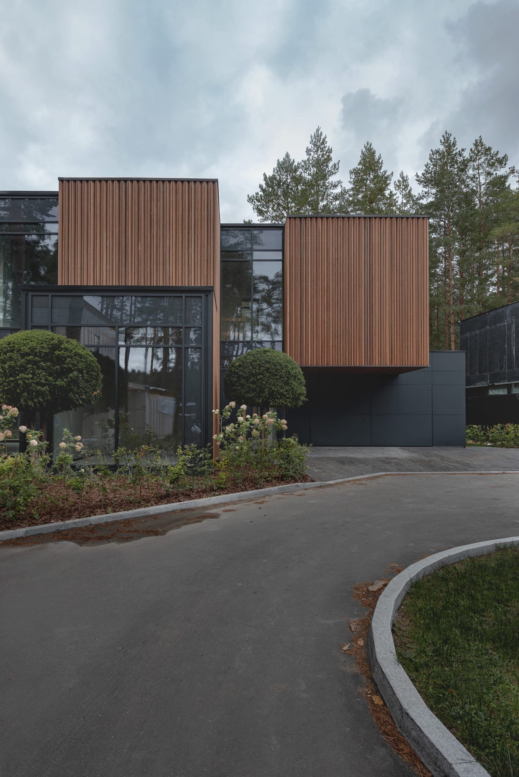 ZEN House — approach, timber volumes rising above clipped topiary