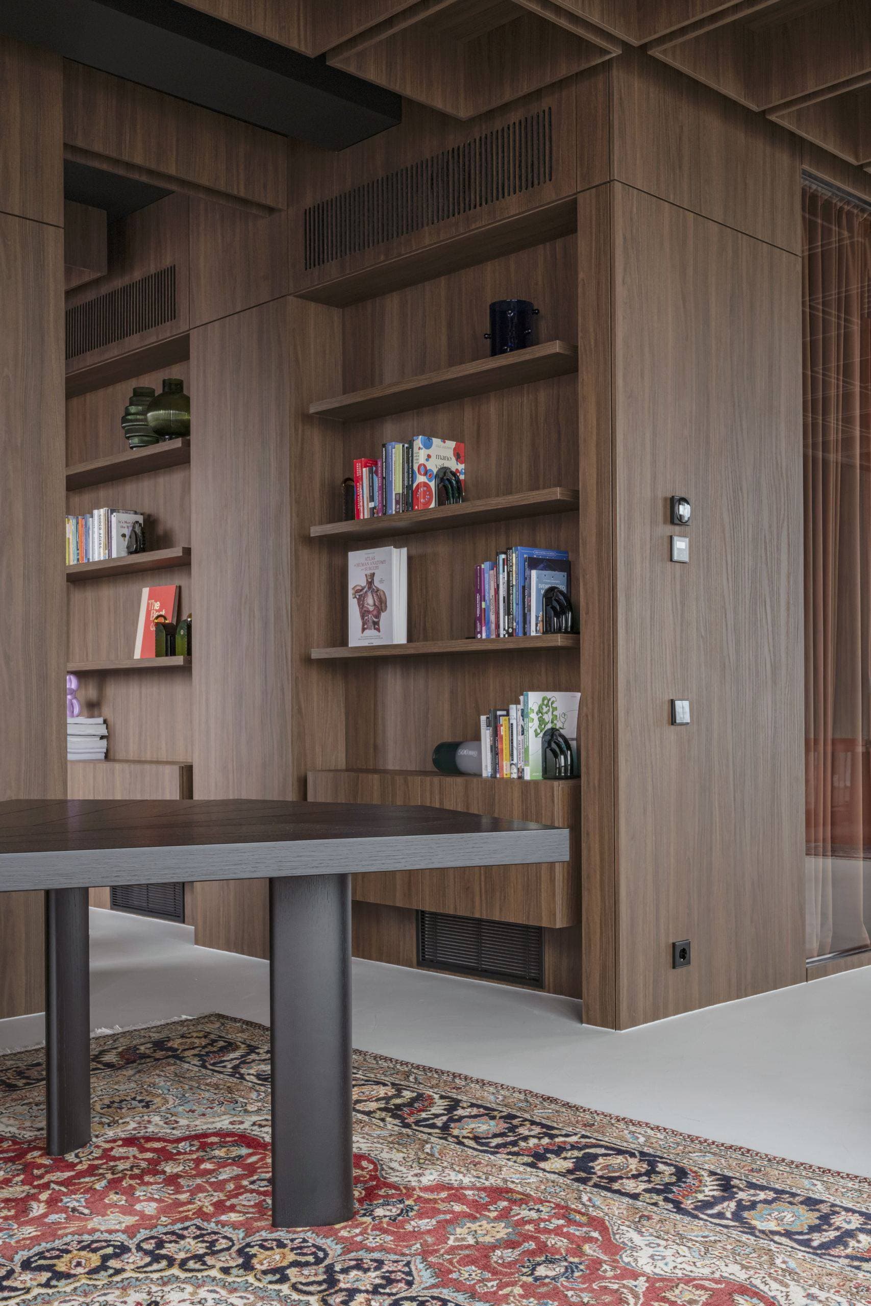 Bespoke Office Interior — walnut bookshelf and desk beneath the coffered ceiling