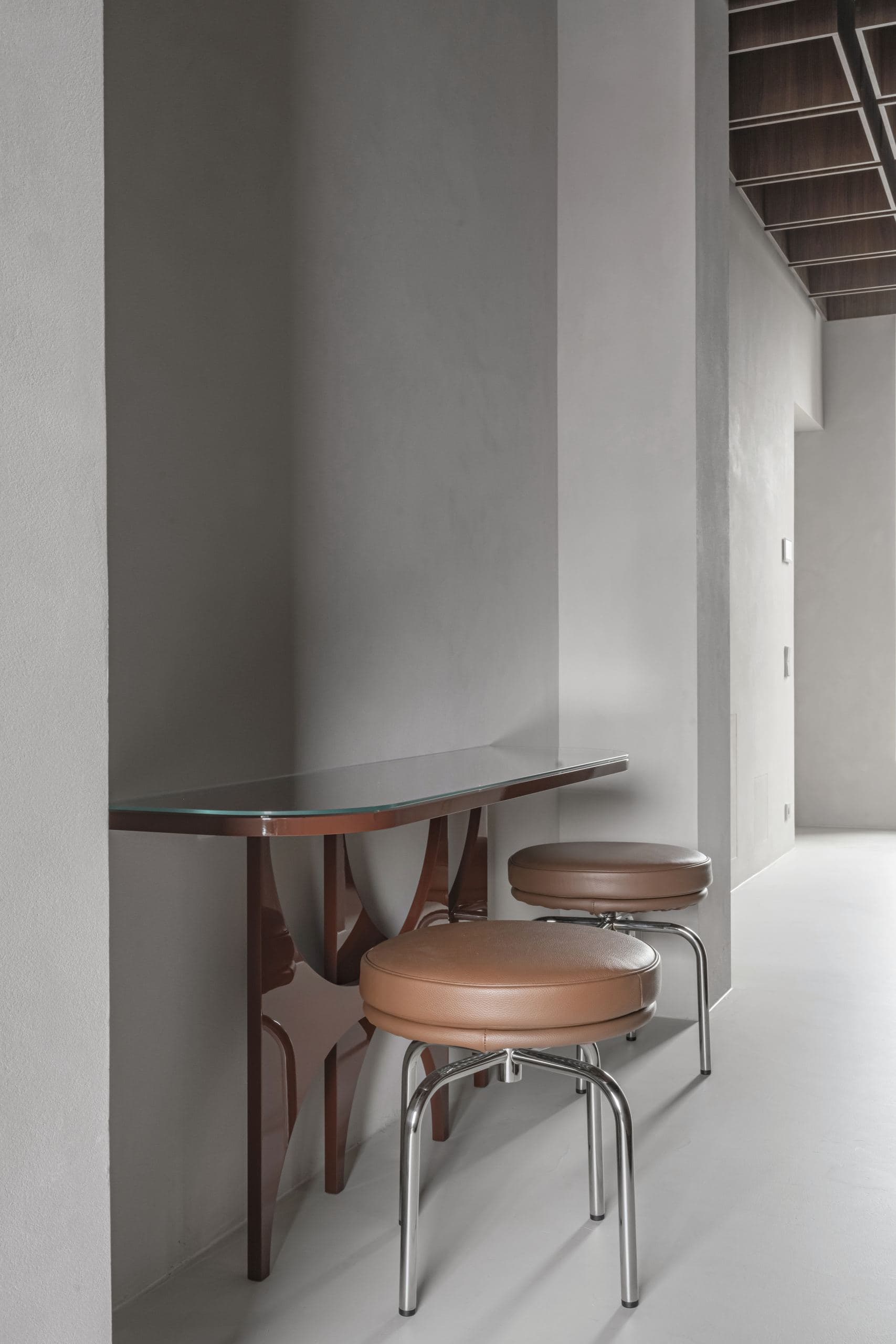 Bespoke Office Interior — small bistro table and stools beside a tall window