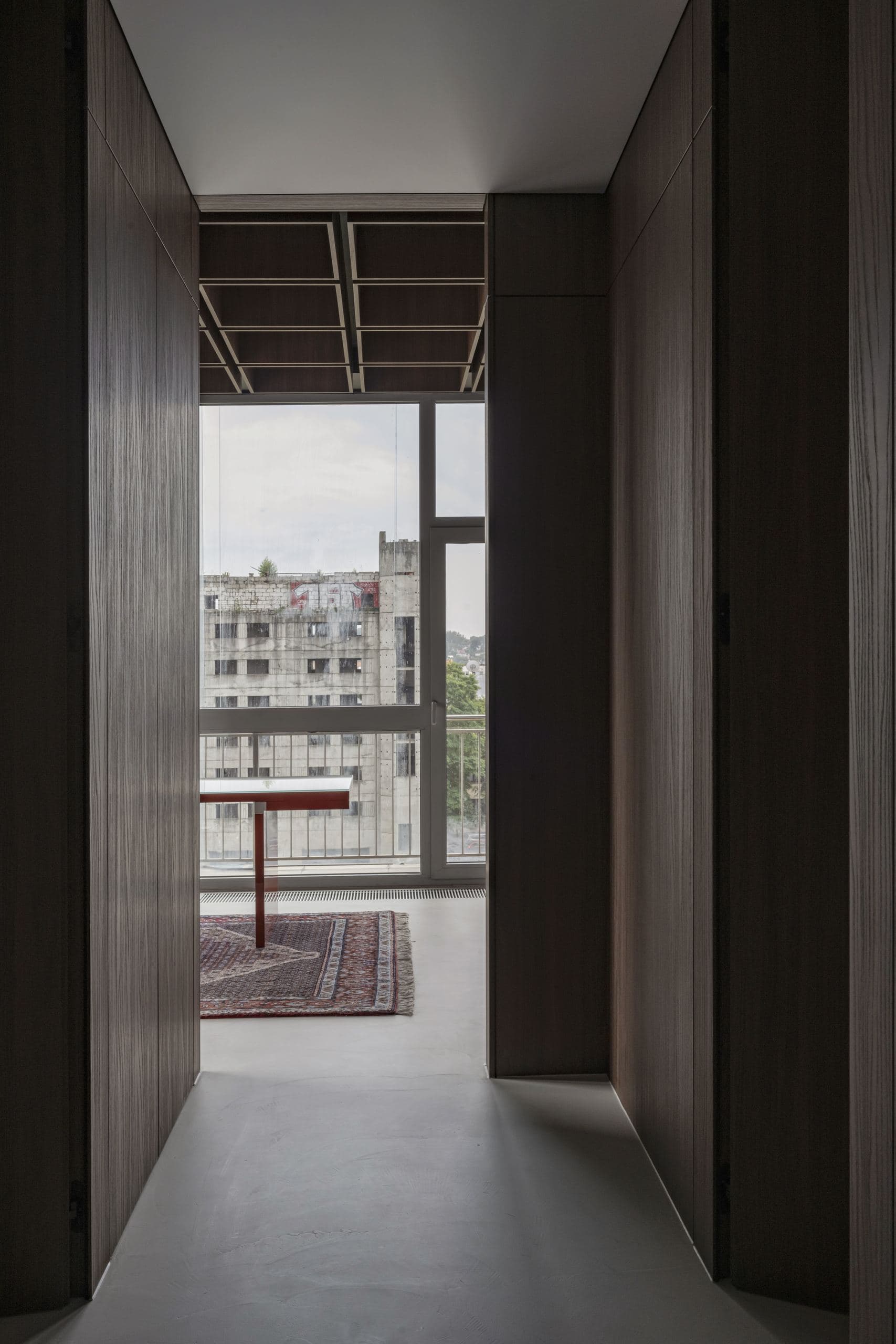 Bespoke Office Interior — corridor of walnut panelling leading to a window