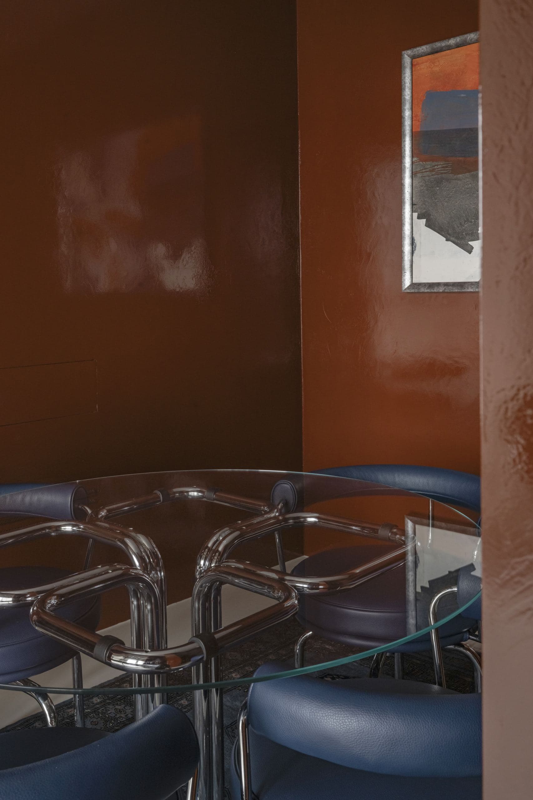 Bespoke Office Interior — chrome chairs around a glass table in an orange lacquered alcove