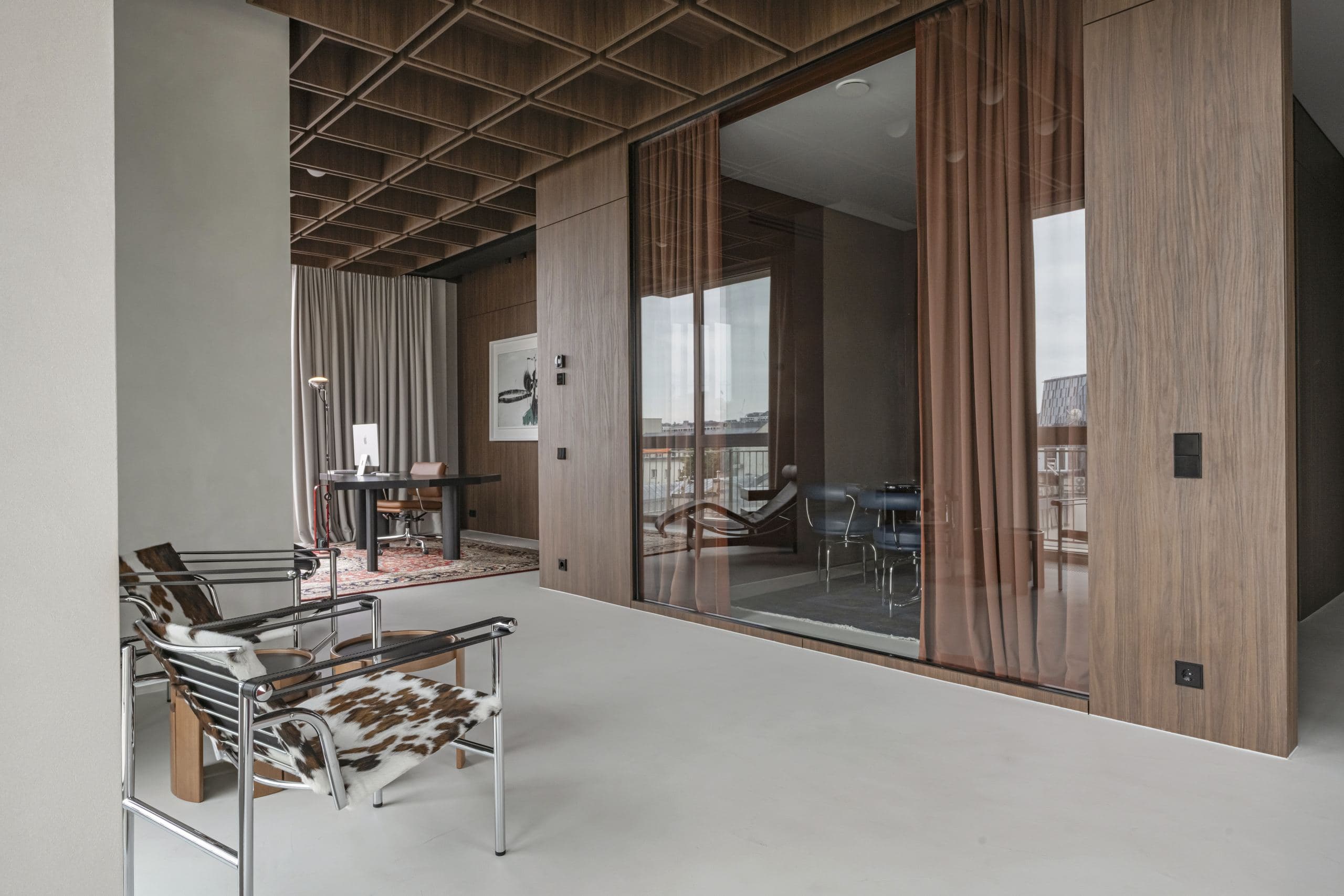 Bespoke Office Interior — leather lounge chair beneath the coffered ceiling, walnut panelling beyond
