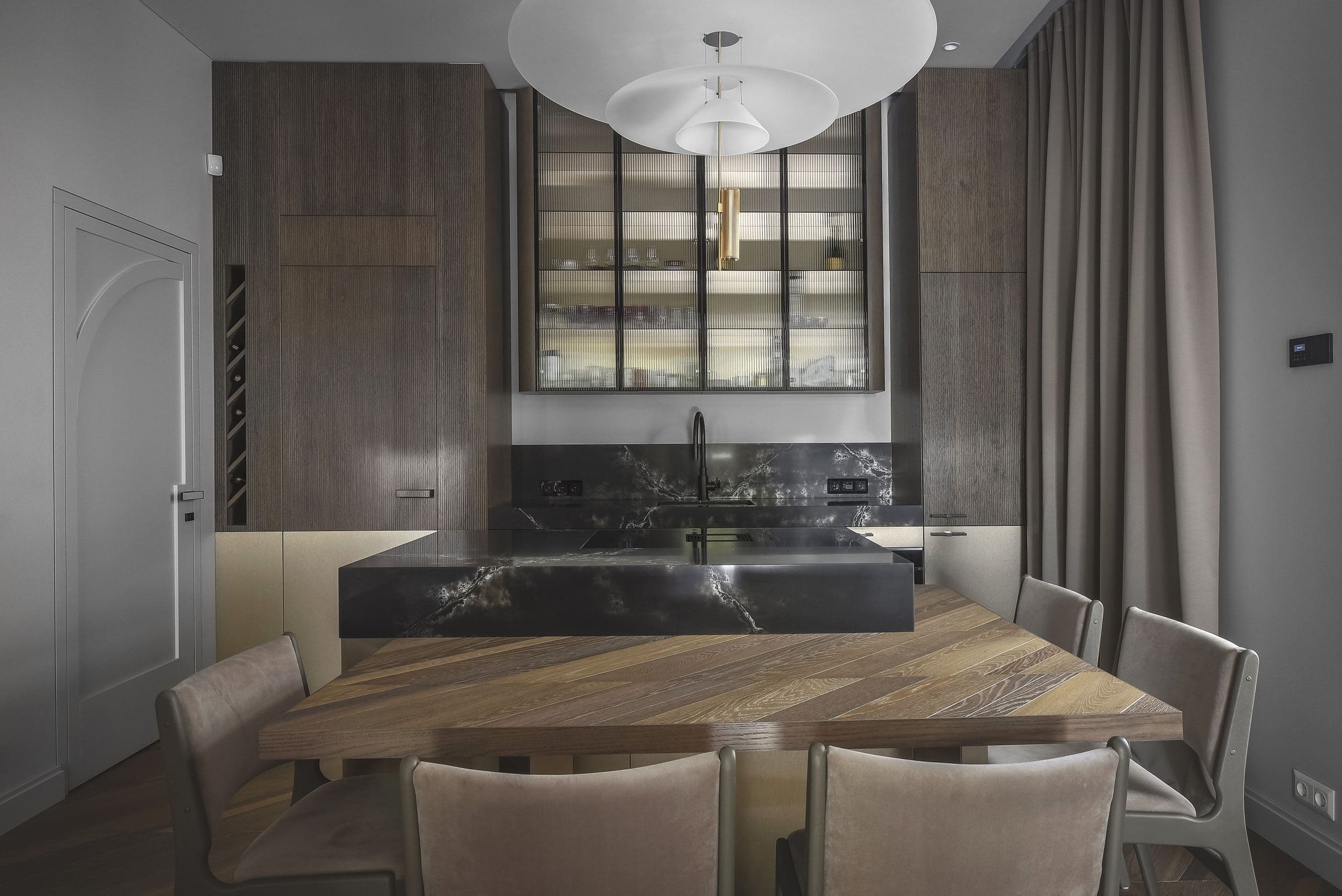 City Avenue Apartment — dining table beneath pendant lighting beside the kitchen