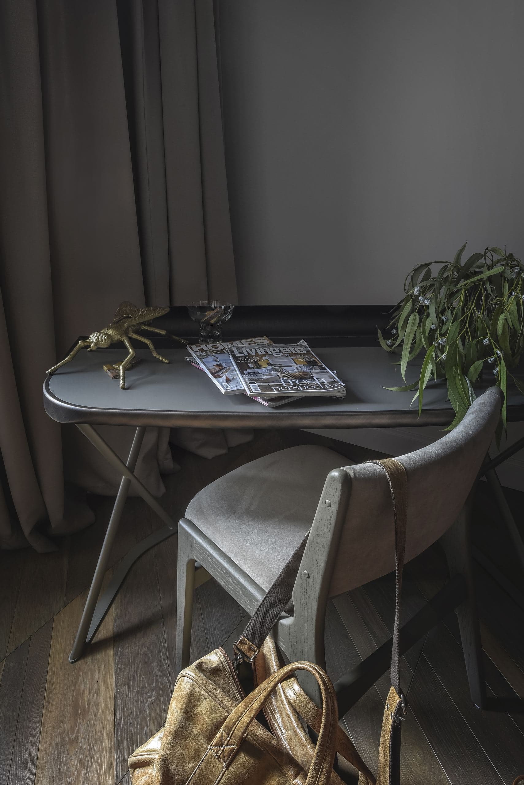 City Avenue Apartment — desk and chair beside a window, a bag resting on the floor
