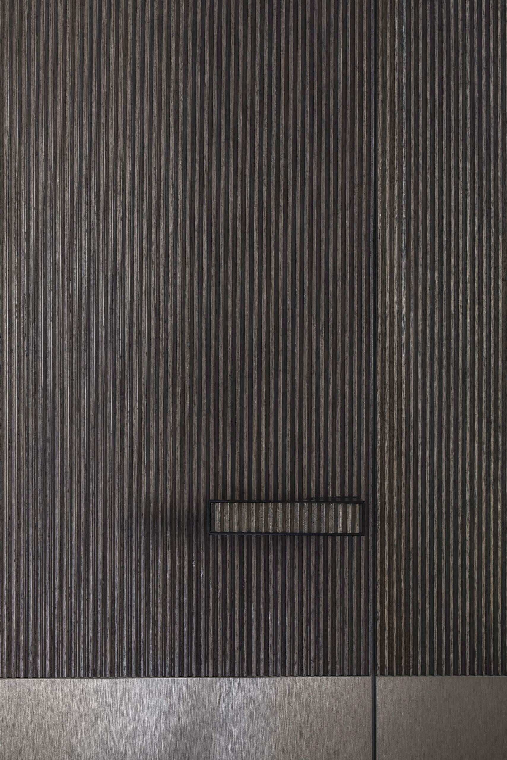 City Avenue Apartment — detail of a ribbed timber door panel