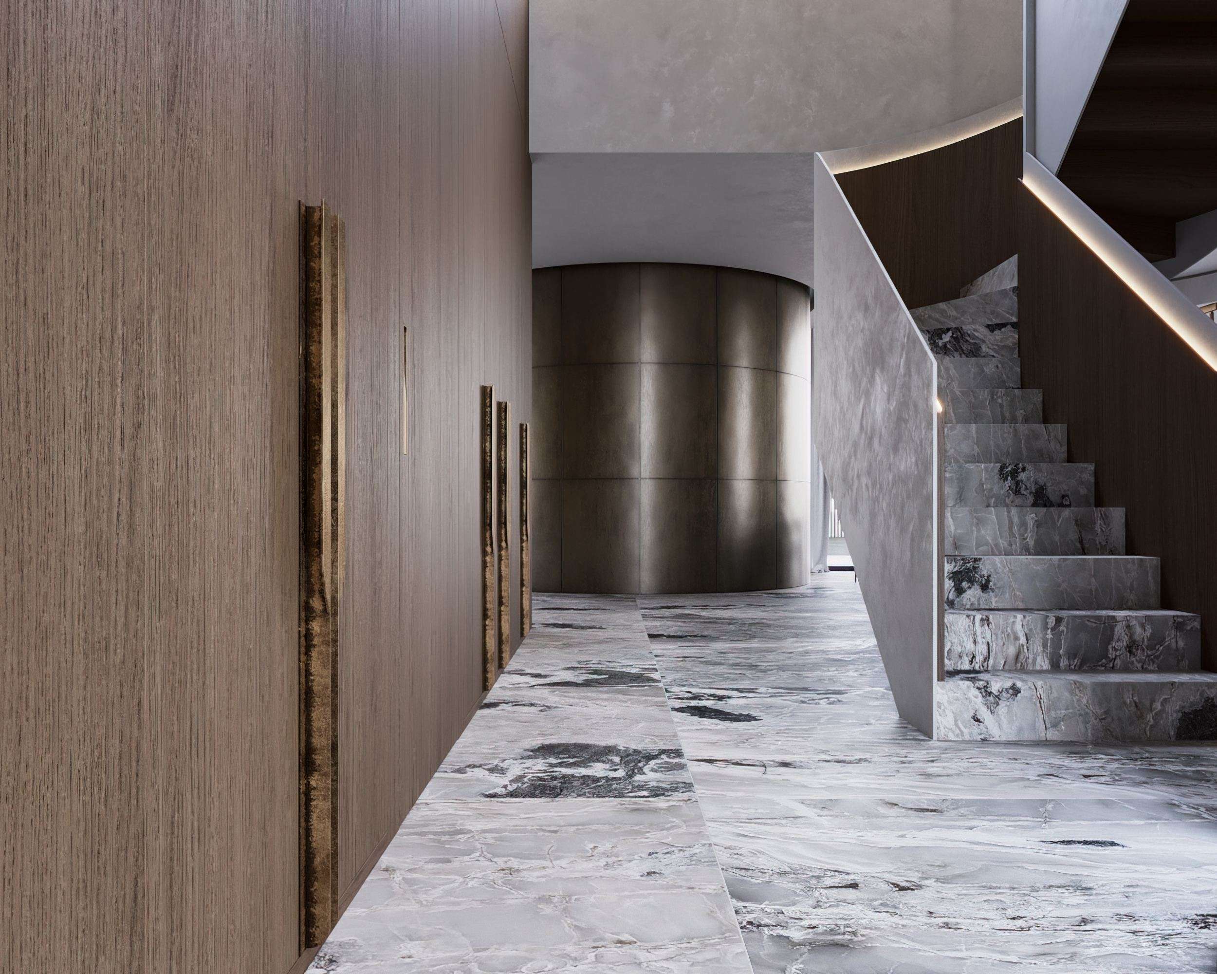 IN JAN House Interior — curved bronze wall panel beside the staircase and stone floor
