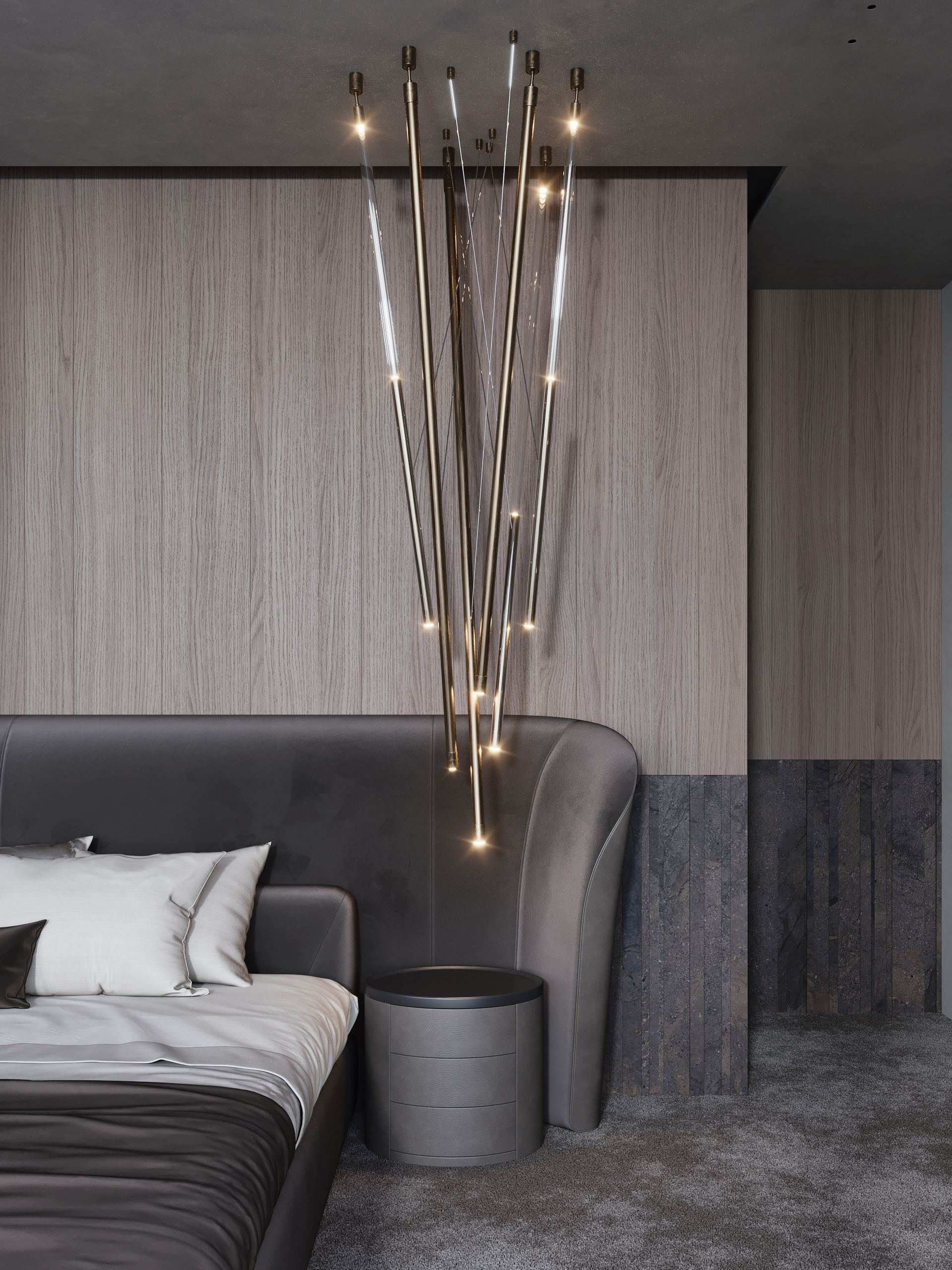 IN JAN House Interior — bed beside a sofa beneath hanging pendant lights