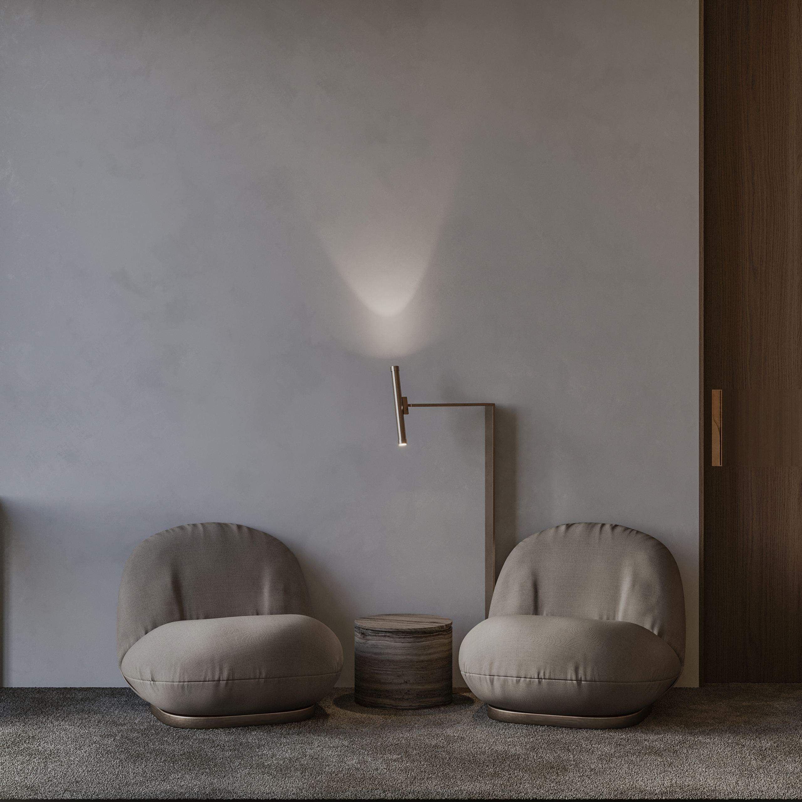 IN JAN House Interior — armchairs and a floor lamp beside a plain plaster wall