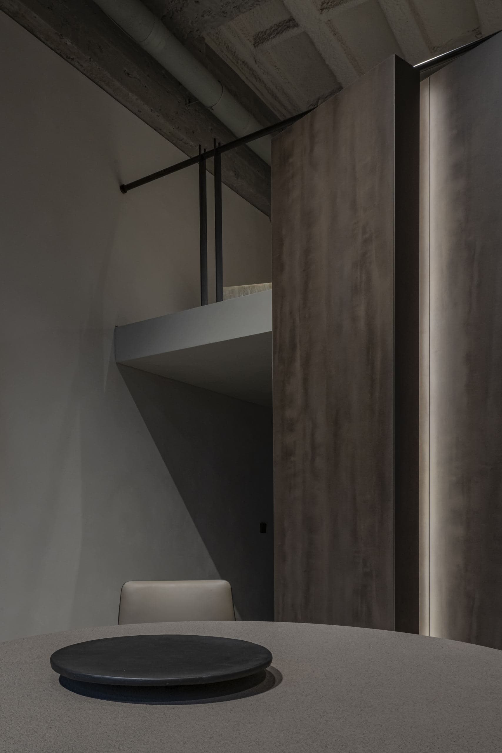 Loft Office — dark timber volume meeting an angled concrete beam