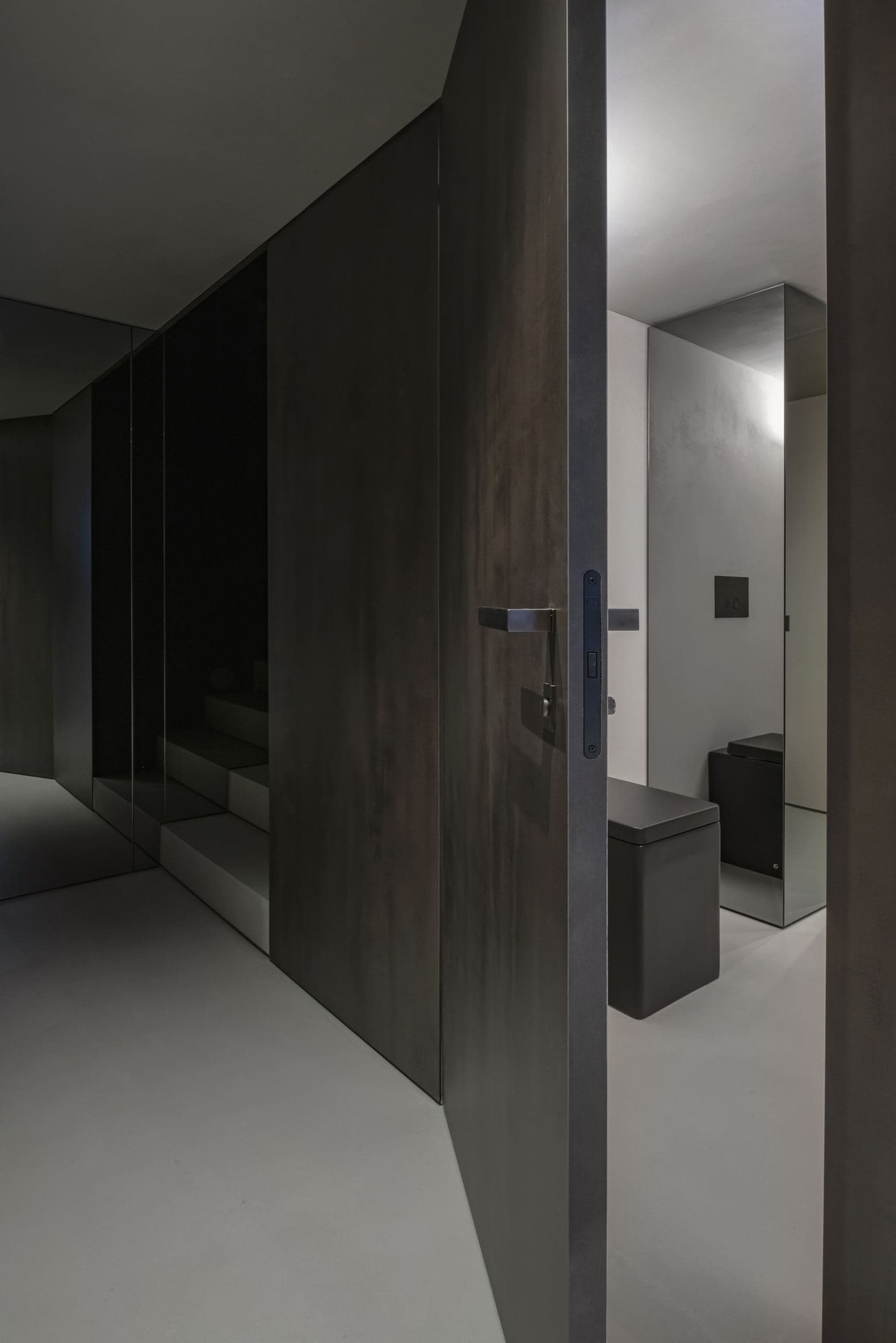Loft Office — timber pivot door opening into a lit room beyond