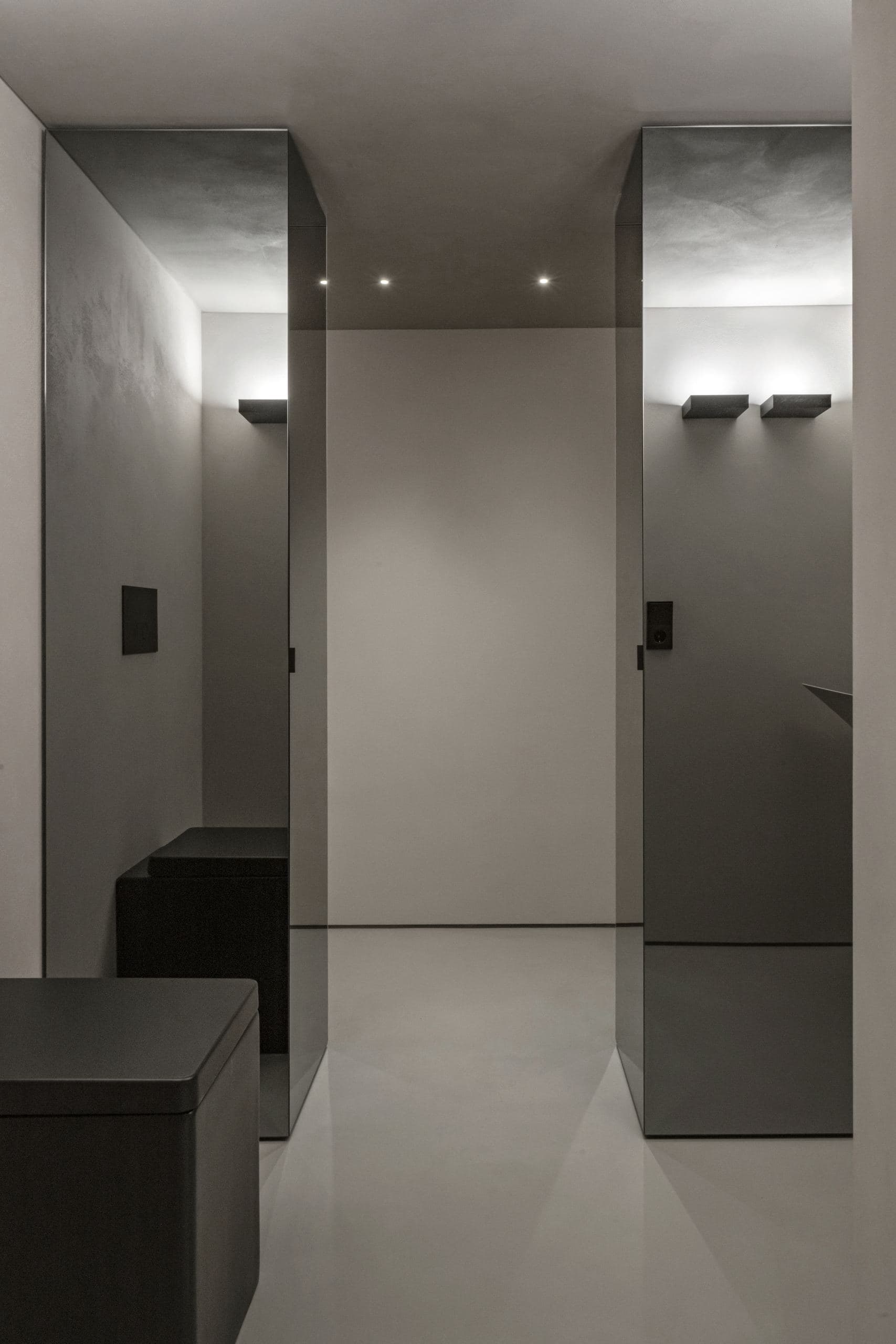Loft Office — two lit alcoves along a microcement corridor
