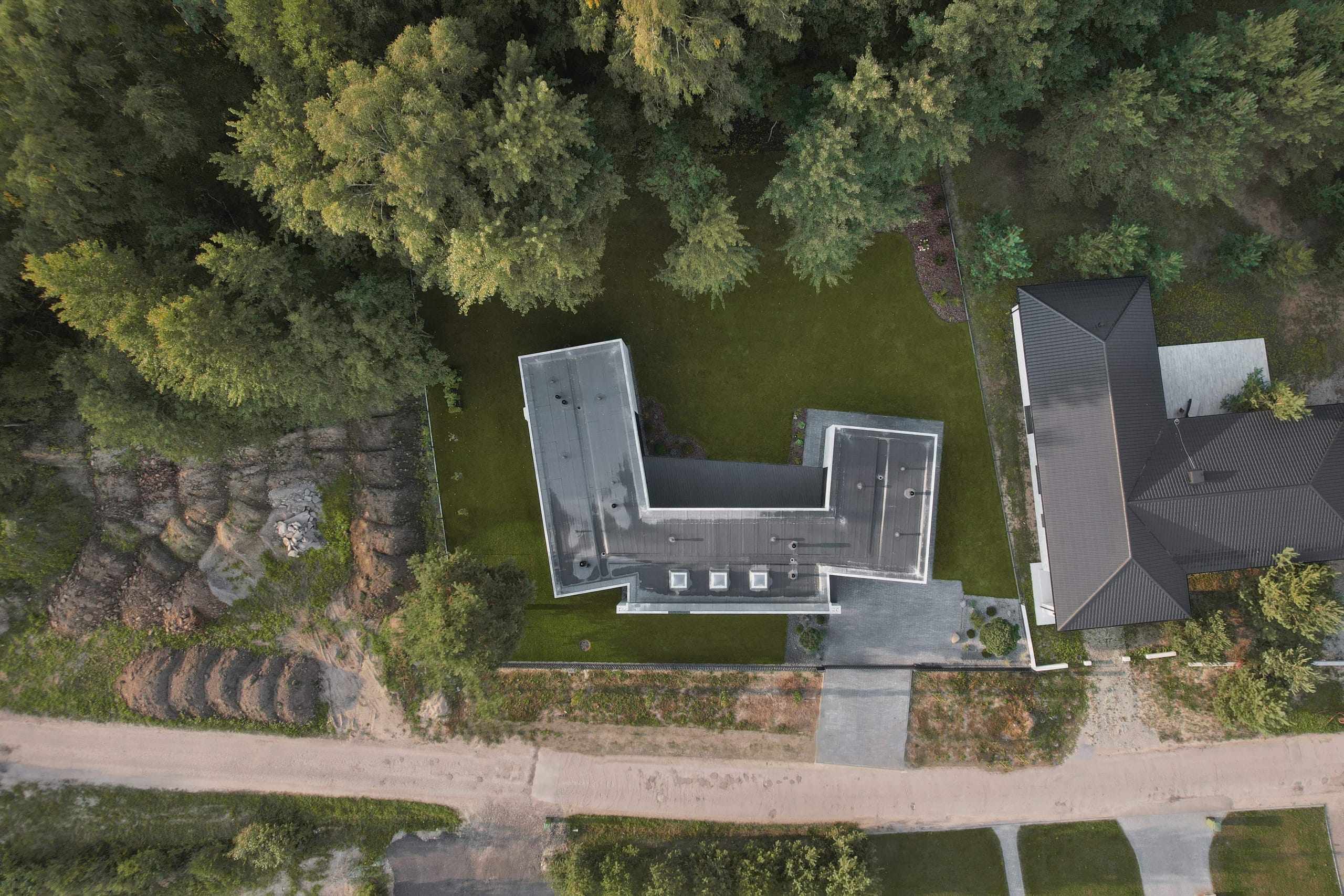 Modern Family House — aerial view, brick volumes wrapped around a lawn