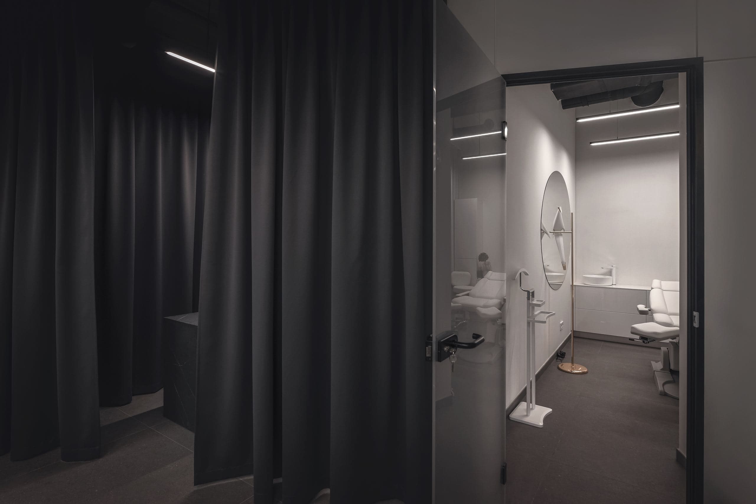 Maestro Beauty Salon — dark curtained corridor opening into a bright white bathroom